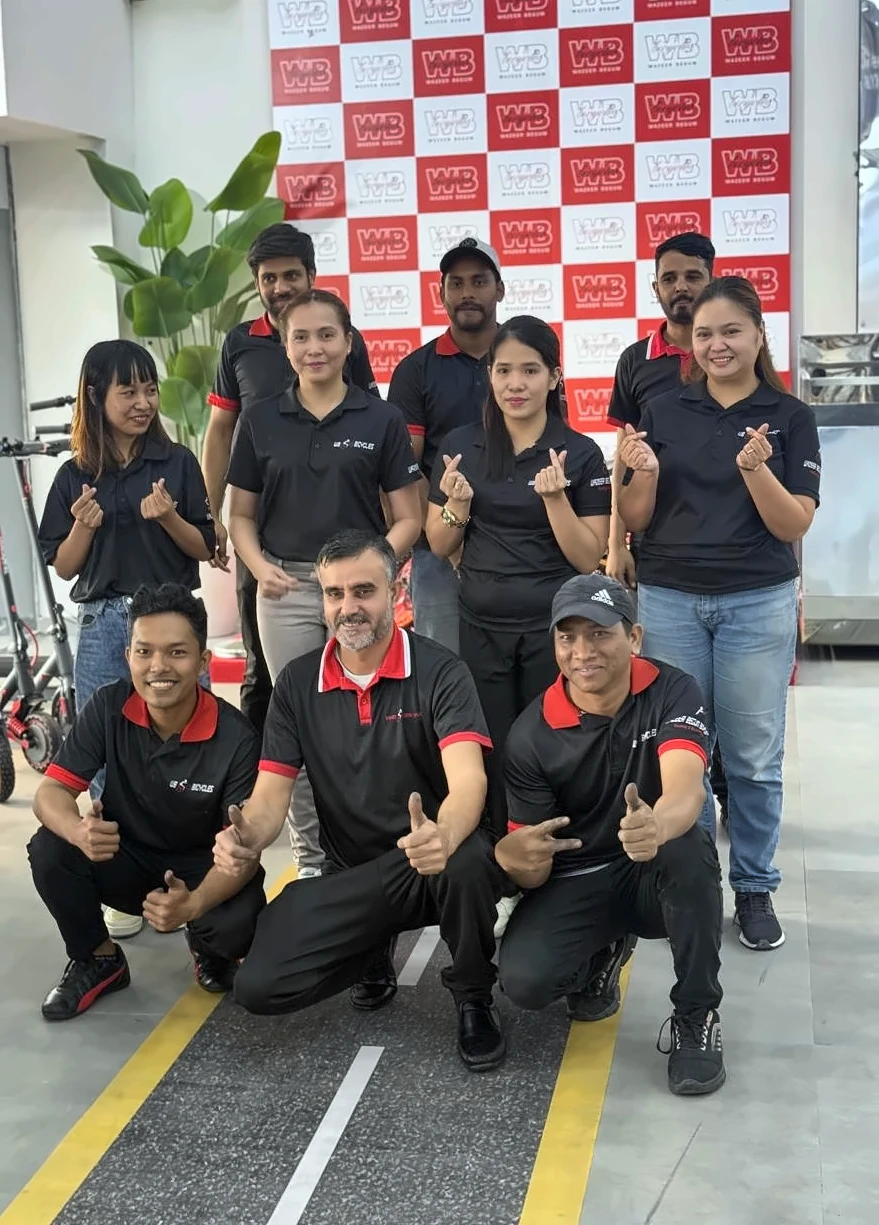 WB Bicycles team in front of the WB backdrop