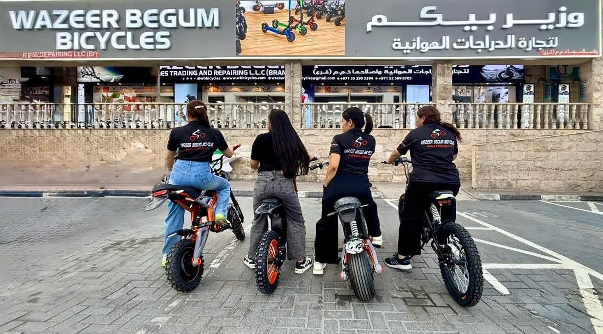 WB Bicycles team riding electric bikes outside our Al Quoz Mall shop in Dubai